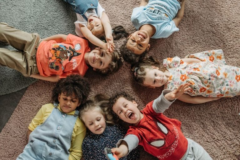 A group of children lying on a carpeted floor, highlighting concerns about carpet's impact on lung health.