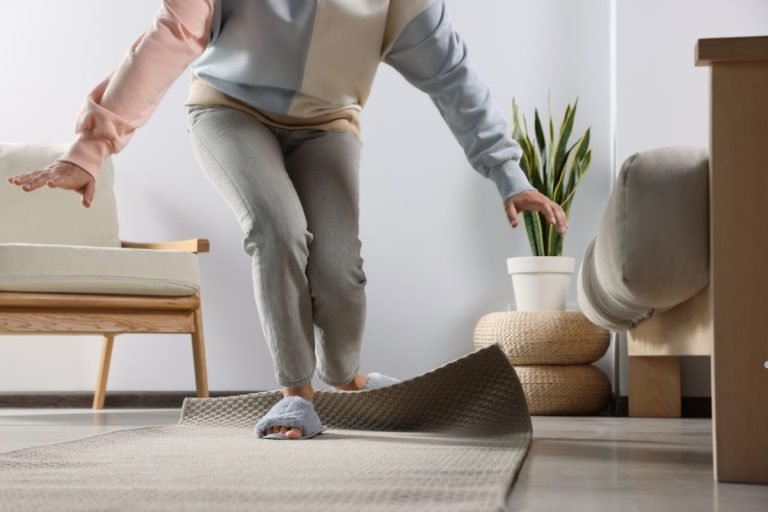 A cozy room featuring a rug, a chair, and a shelf, highlighting smarter carpet choices for Miami homes.